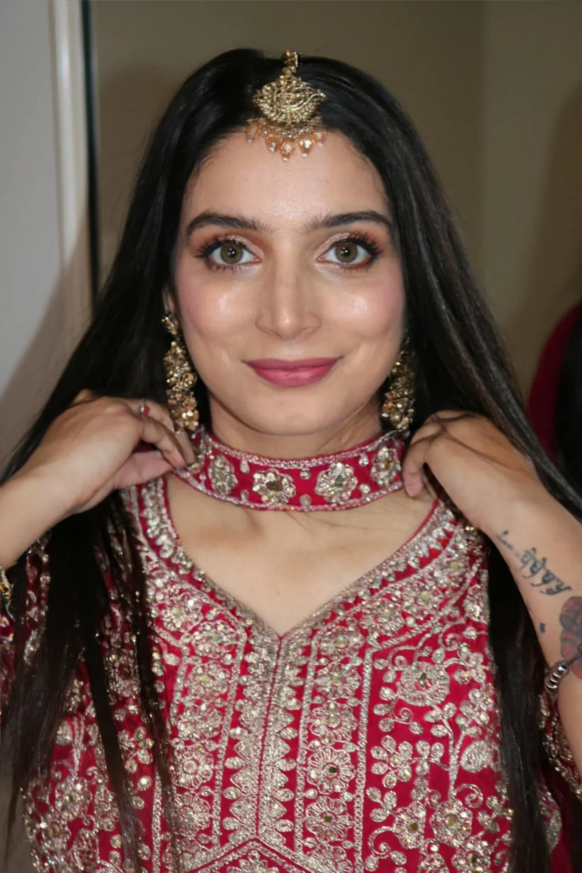 South Asian bridal makeup close-up with red and gold details